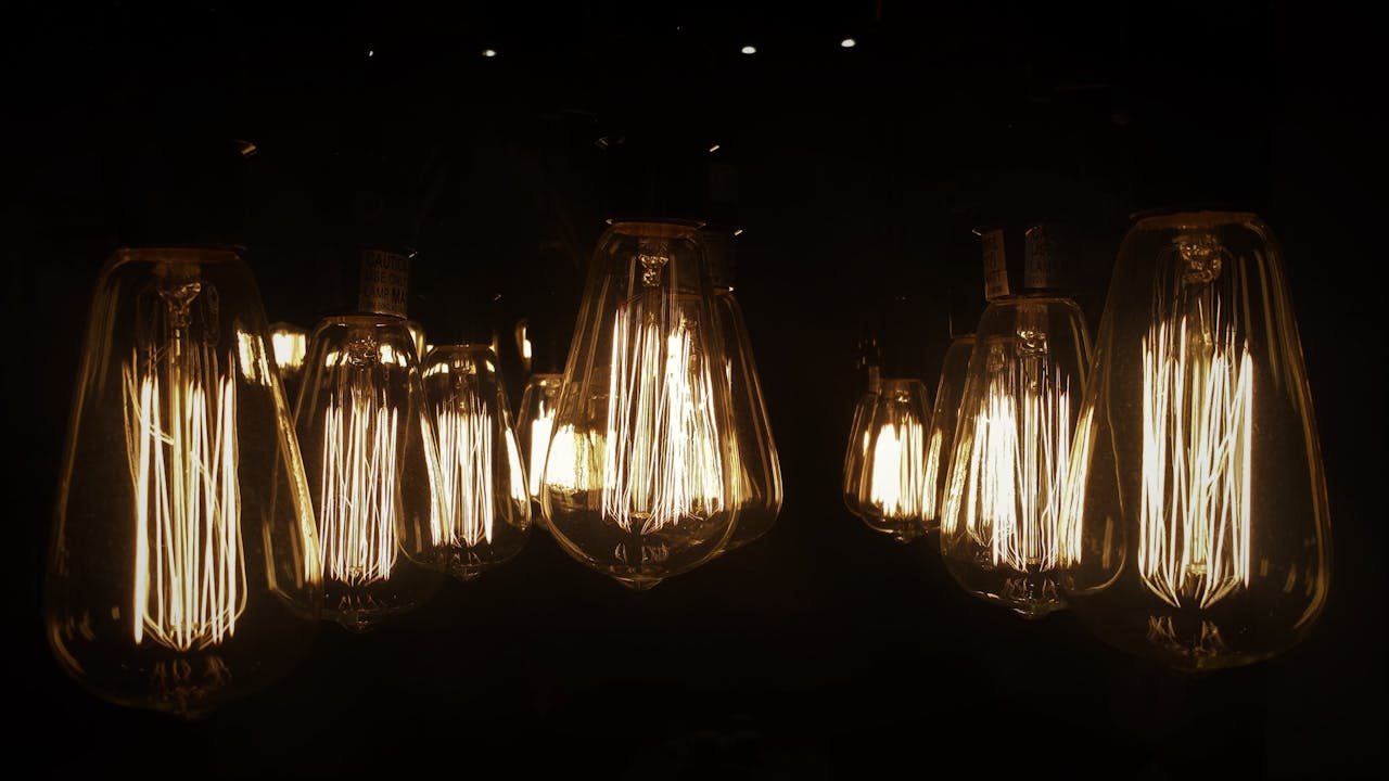 Warm glow of vintage Edison bulbs creates a cozy ambiance in a dark room.